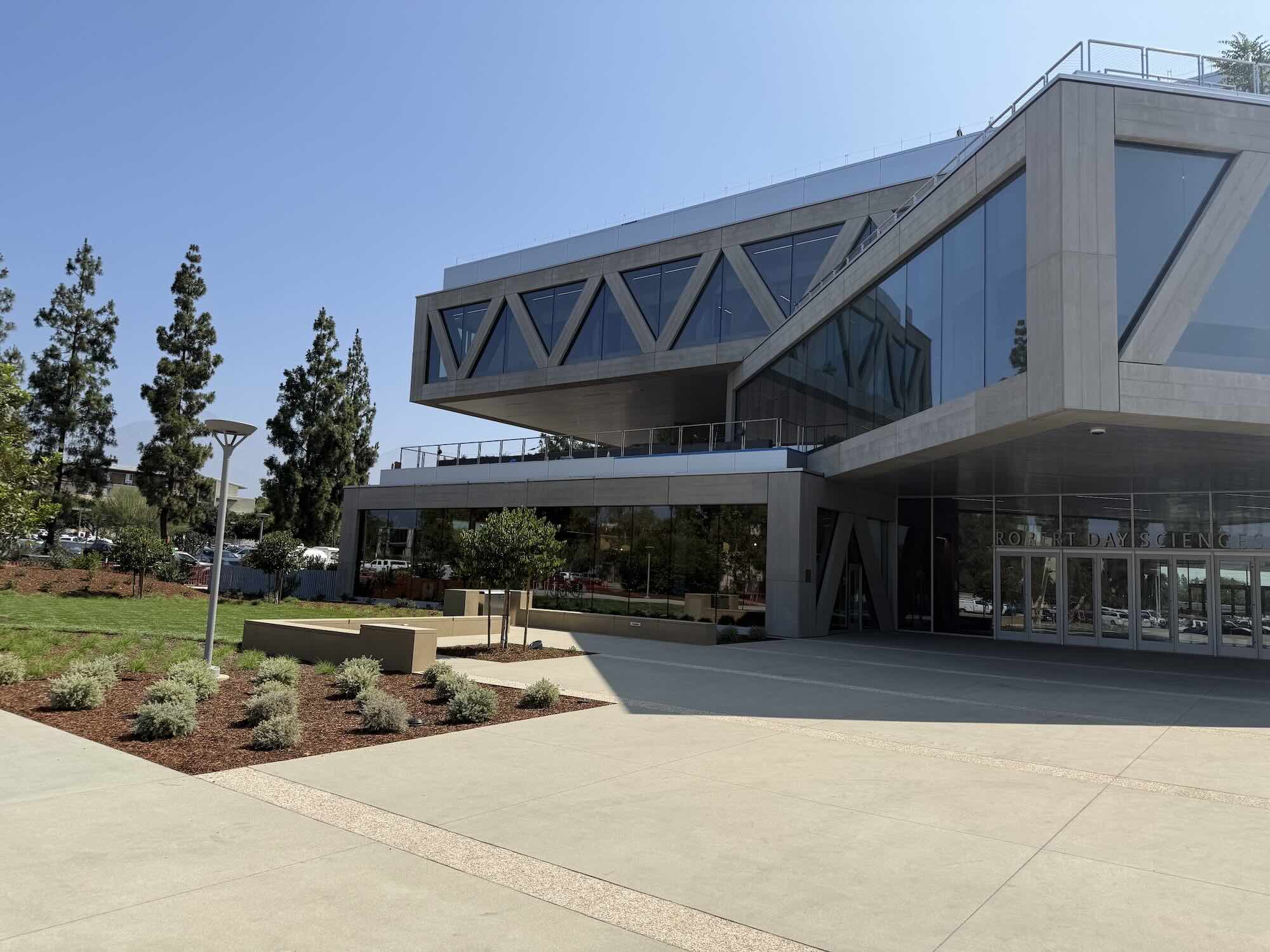 Exterior view of the Robert Day Sciences Center with glass facade and terraces